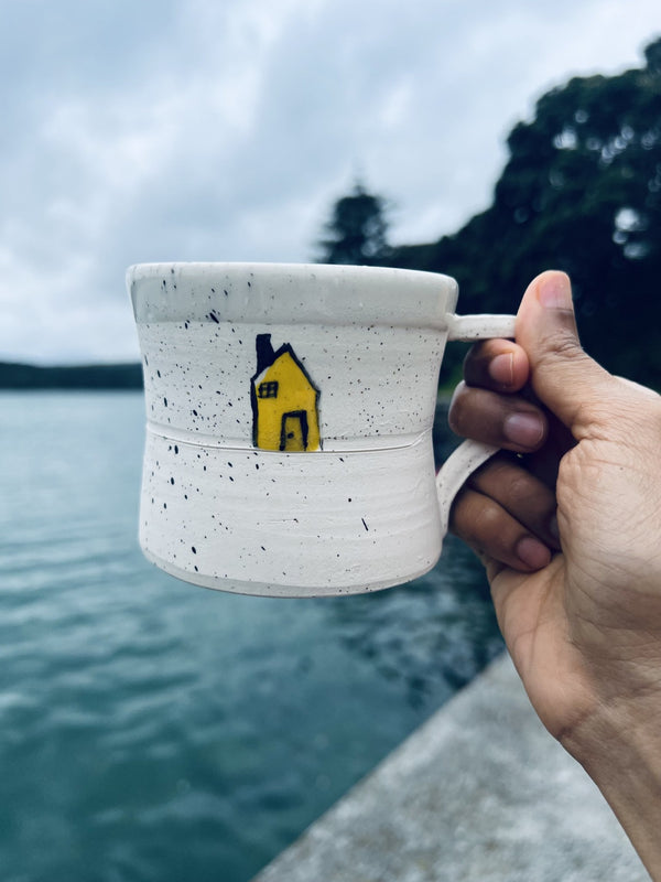 A handmade ceramic mug with a cute house design on it | Artoon